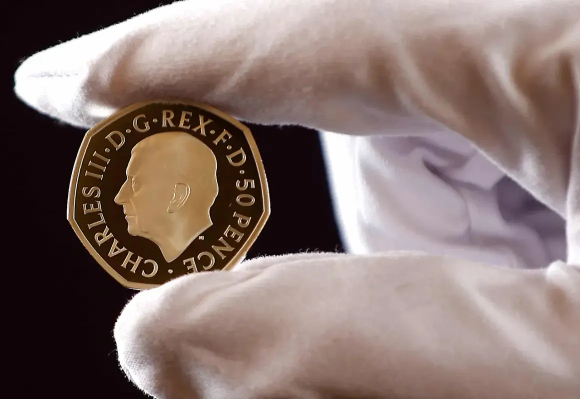 Złoty suweren z wizerunkiem Karola III, trzymany w białej rękawiczce.