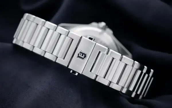 Metalowa bransoleta zegarka Eberhard z wygrawerowanym logo.